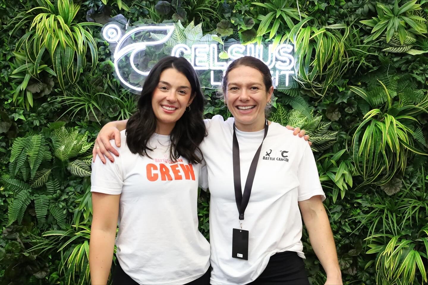 Two Battle Cancer team members posing at a branded London photo booth experience
