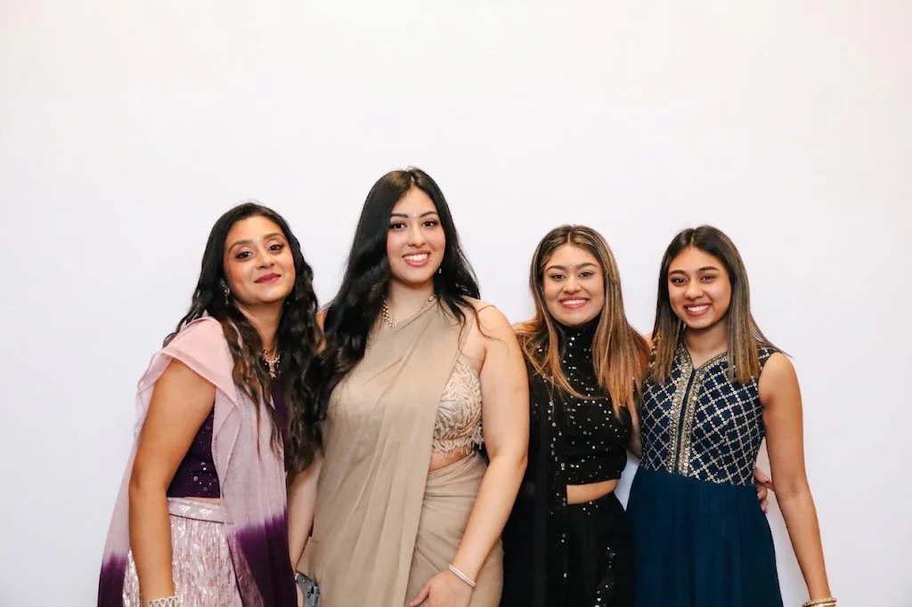 Four guests posing together at a London photo booth experience