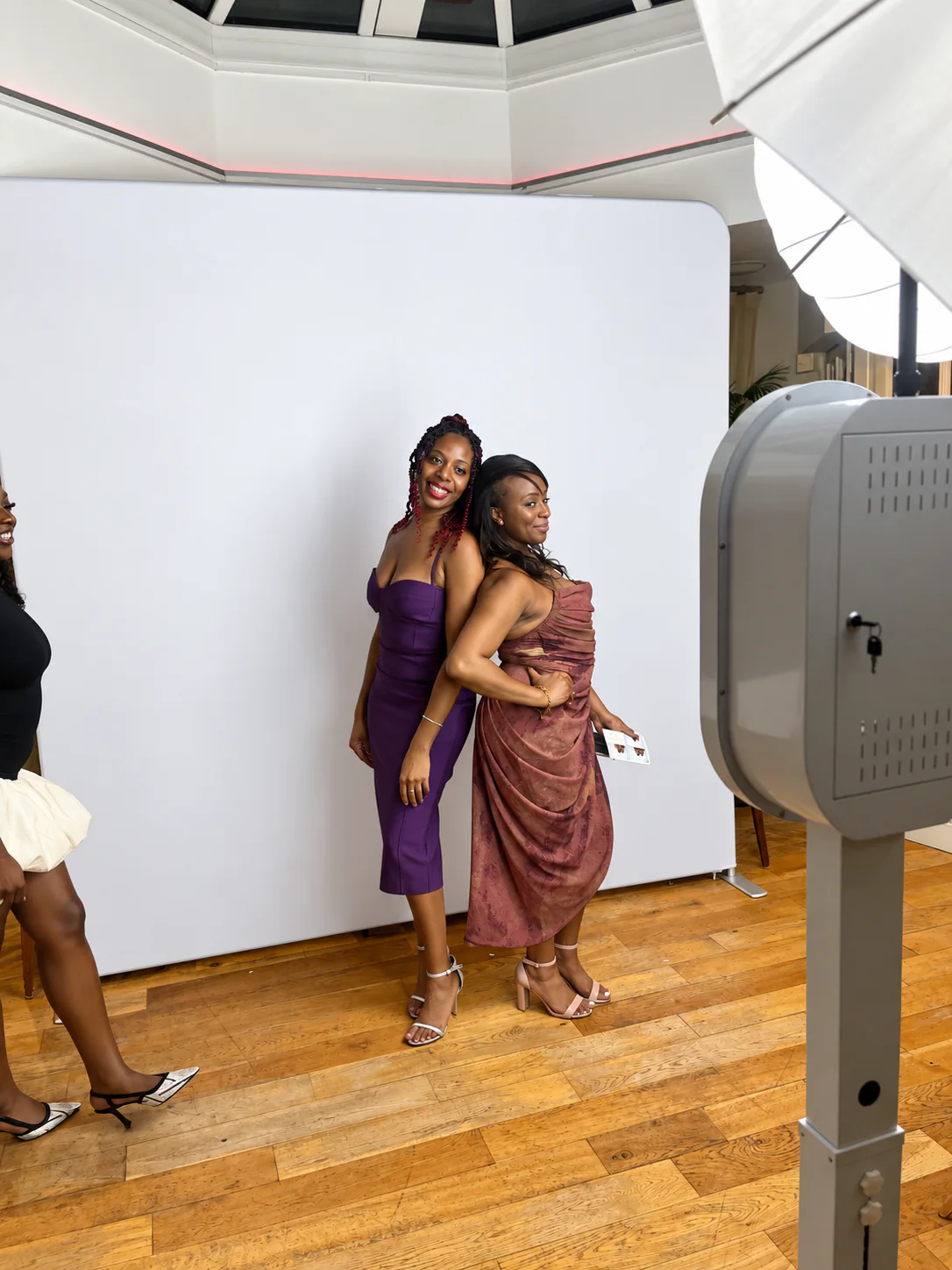 Wedding guests posing beside an Impulse Booth photo booth setup in London